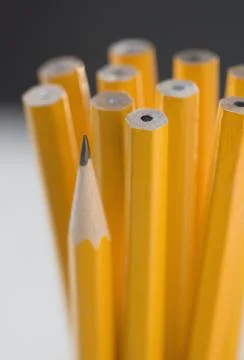 Unsharpened pencils with one sharpened 스톡 사진