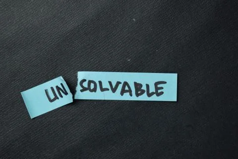 Unsolvable to be Solvable write on sticky notes isolated on office desk. Stock Photos
