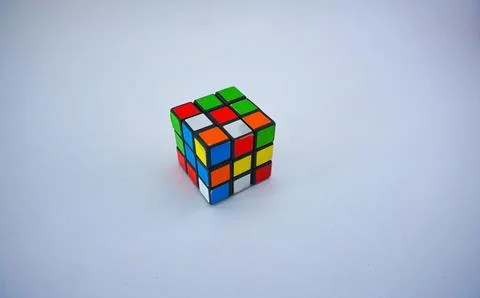 Unsolved Rubik's cube against a white background. Stock Photos