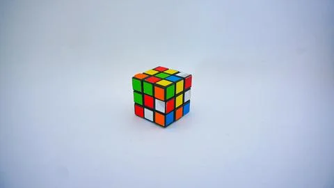 Unsolved Rubik's cube against a white background. Stock Photos