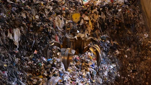 Unsorted garbage is collected by a special crane claw for incineration factory. Stock Footage 234677735