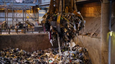 Unsorted garbage is collected by a special crane claw for incineration factory. Stock Footage 234680056