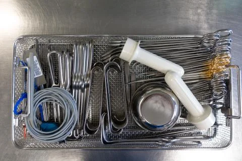 Unsorted surgical instruments after cleaning in the washing machine Stock Photos