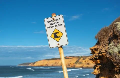 Unstable Cliffs Keep Clear sign along limestone coastline Stock Photos