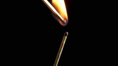 An unsuccessful attempt to light one match with another. black background Stock Footage 153754298