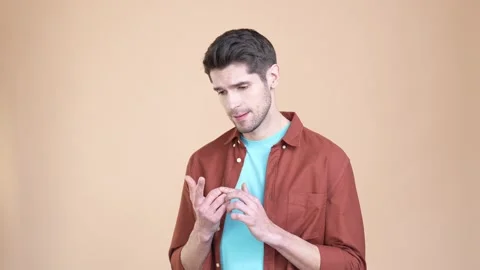 Unsure guy focused count fingers list decision isolated pastel color background Stock Footage 169938436