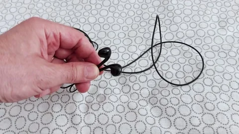 Untangling Earbuds: Simple Tricks for Quick Fixes Stock Footage 311040987