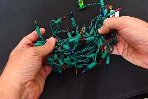 Untangling String of Christmas Lights Foto stock