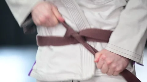 Untaying brown belt close up Video stock 332160858
