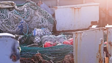 Untidy clutter of fishing nets on deck of rusty trawler Pan UP shot Stock-Footage 307371225