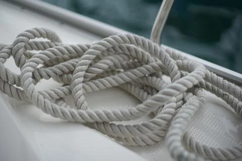 An untidy dropped docking line on deck of a sail boat Stock Photos