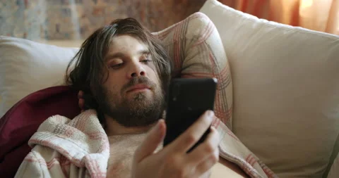 Untidy slacker, divorced unemployed man lazy lying on couch with smartphone Vídeos de archivo 238425208