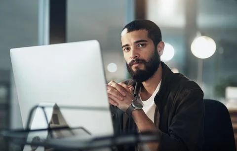 Until the task is done, Im staying right here. a young businessman using a Stock Photos