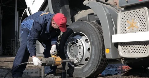 Untitled Project 4 mechanic unscrews wheel wrench truck Stock Footage 101106592