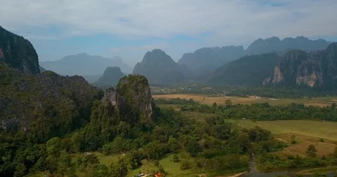 Untitled Projectflying around mountain between ground and cloudy sky, Vang Vieng Video stock 108469768