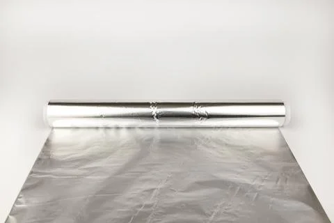 An untwisted roll of foil on the table. Stock Photos