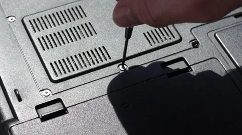 Untwisting screws on a laptop's back Stock Footage 66755978