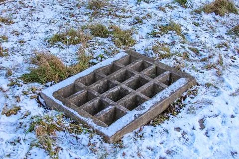 Unused concrete slab with grid pattern sits in snowy landscape Stock Photos