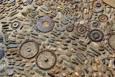 Unusual floor with pattern from pebbles and metal details Stock Photos