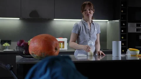 An Unusual Kitchen Scene Featuring an Oversized Pumpkin in a Vibrant and Creativ Stock Footage 301436408