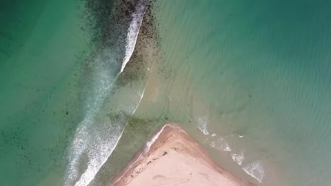 An unusual sandy beach of a coal shape and a turquoise clear sea with waves, Stock Footage 245341755