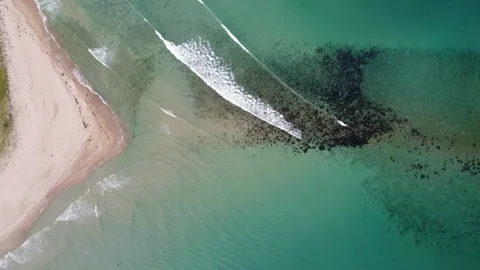 An unusual sandy beach of a coal shape and a turquoise clear sea with waves, Stock Footage 245470657