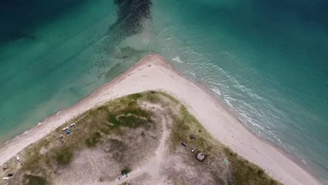 An unusual sandy beach of a coal shape and a turquoise clear sea with waves, Stock Footage 245470676