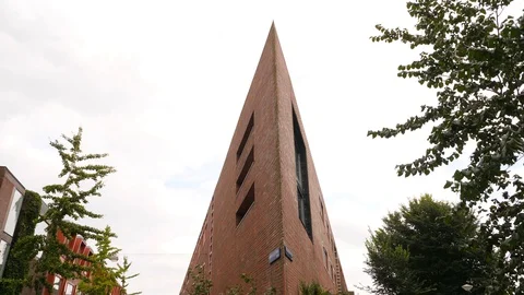 Unusual sharp angle of wall corner at house building, tilt down shot Video stock 129981165