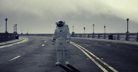 Unusual sighting of astronaut standing on empty road during foggy day Stock Illustration
