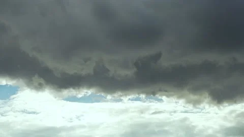 Unusual Sky Dark Gray Cloud over Sunny White Clouds in Blue Sky Timelapse. Thund Stock Footage 220549180