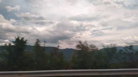 An unusually beautiful cloudy sky over green mountains Stock-Footage 332330396