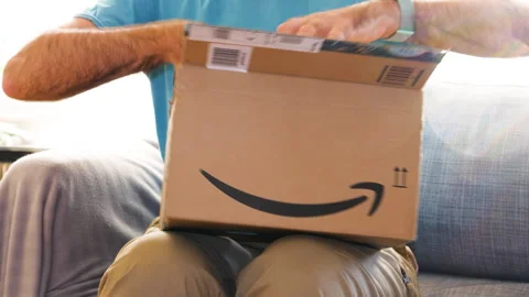 Unveiling Nikon 85mm Lens from Amazon Box Stock Footage 303868167