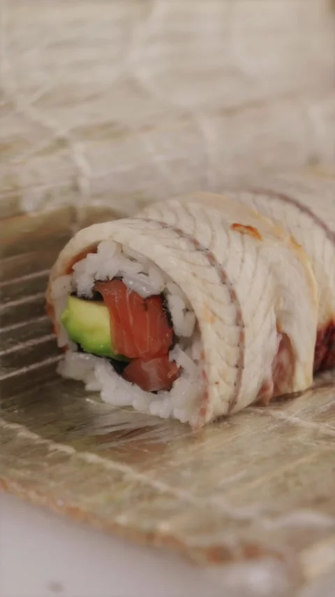 Unveiling unagi eel sushi roll filled with salmon and avocado Stock Footage 337119220