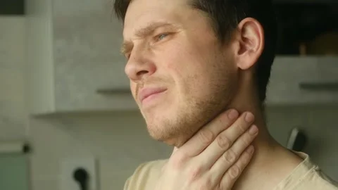 Unwell man touching his sore throat Video stock 337828186
