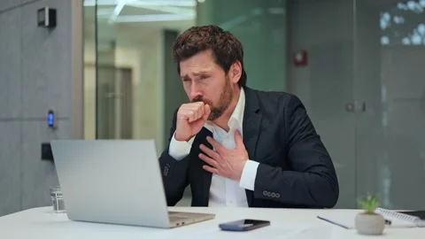 Unwell Worker Experiencing Persistent Cough at Office Desk 스톡 동영상 330041114