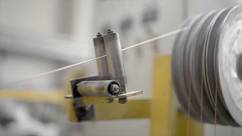Unwinding copper wire for insulation production Stock Footage