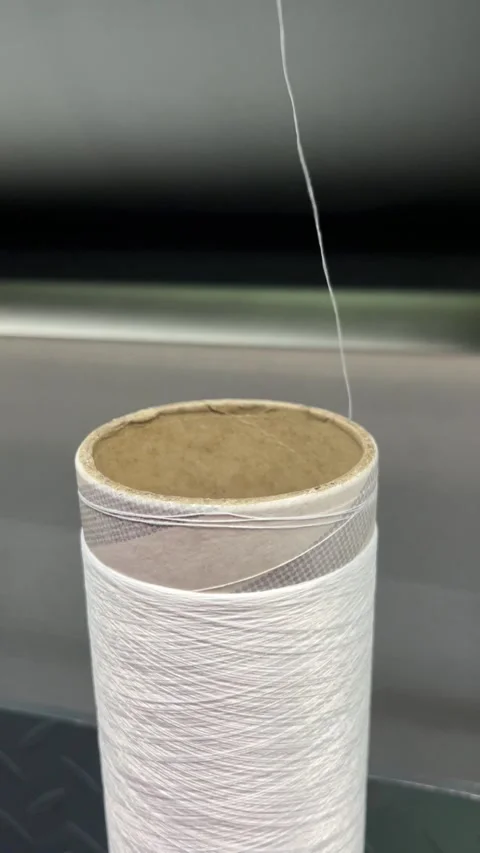 Unwinding thread from a spool in the textile industry Video stock 264948831