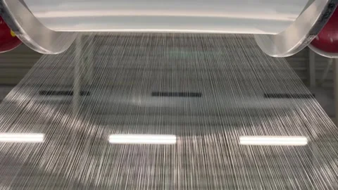 The unwinding of the threads from the bobbin of the warp of the knitting machine Stock Footage 264052214