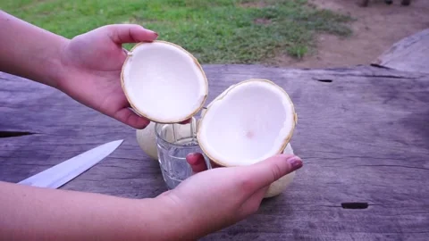 Unwrap the aromatic coconut to prepare a snack. Stock Footage 164032451
