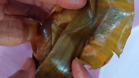Unwrapped banana leaf snacks Stock Footage 265765997