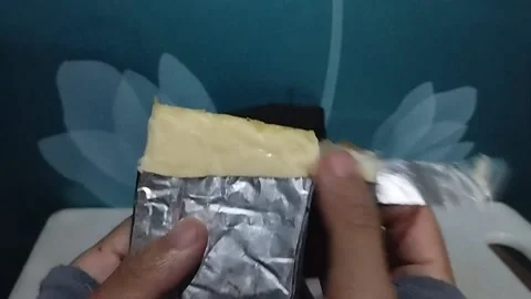 Unwrapping a Block of Cheese Stock Footage 229303421
