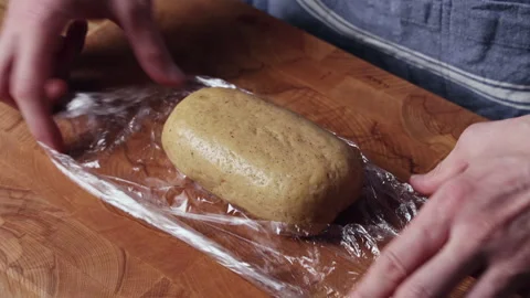 Unwrapping Dough From Plastic Wrap By Hand Close View Видео 333597571