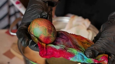 Unwrapping dyed Easter egg in home setting close up 2026 Stock Footage 332677928