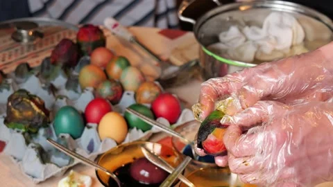 Unwrapping dyed Easter egg in home setting close up 2026 스톡 동영상 332874708