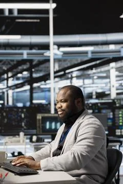 Upbeat data center IT expert uses PC to update servers tech, configuring gear Stock Photos