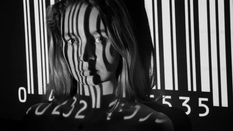 UPC code projected onto attractive young womans face. Black and white. 스톡 동영상 187139518