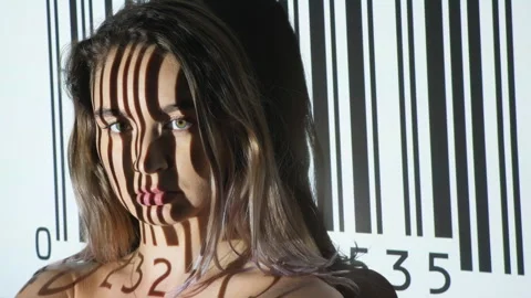 UPC code projected onto defiant young womans face. 스톡 동영상 187138554