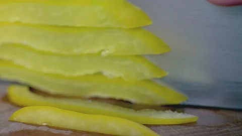 Upclose chopping of yellow pepper Stock Footage 134870374
