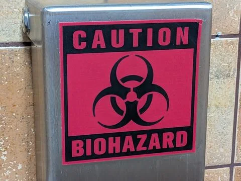 Upclose red and black Caution Biohazard sign on a metal object Stock Photos