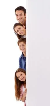 Upcoming family events. Cant wait. Studio shot of a happy family peeking out Stock Photos